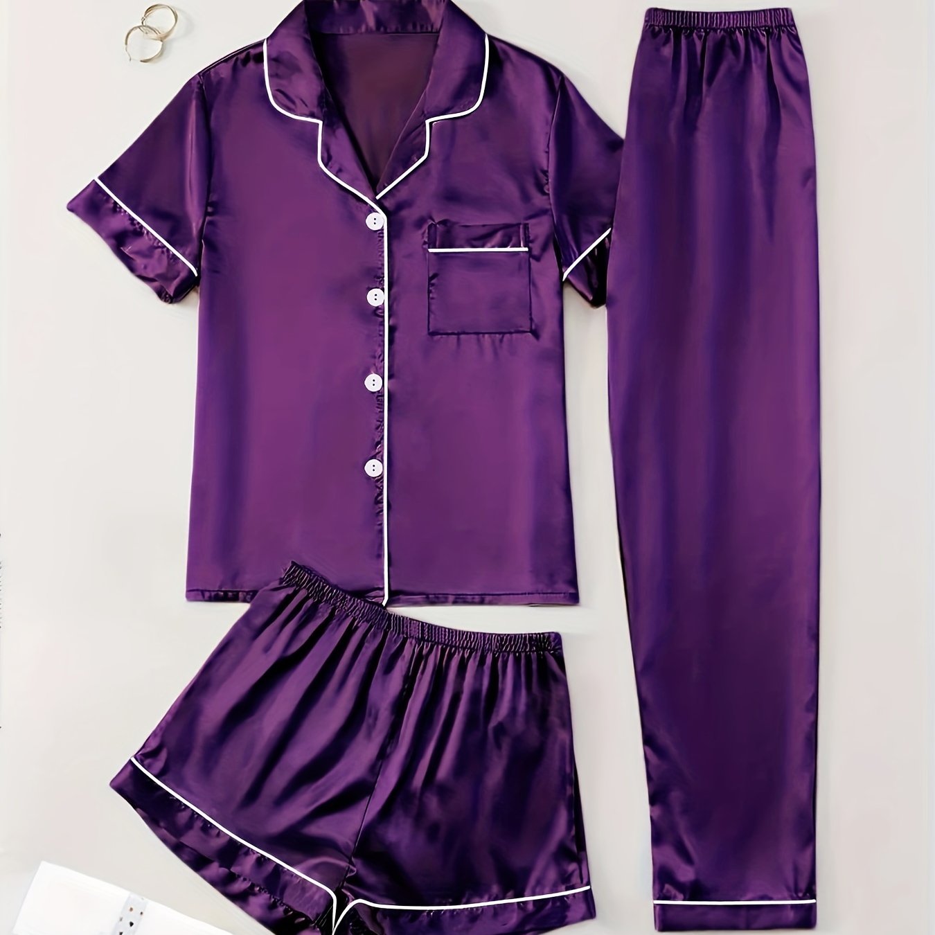 3-piece summer satin pajama set for women featuring collared shirt, long pants, and shorts. Made of 95% polyester and 5% elastane. Available in sizes S-XL.