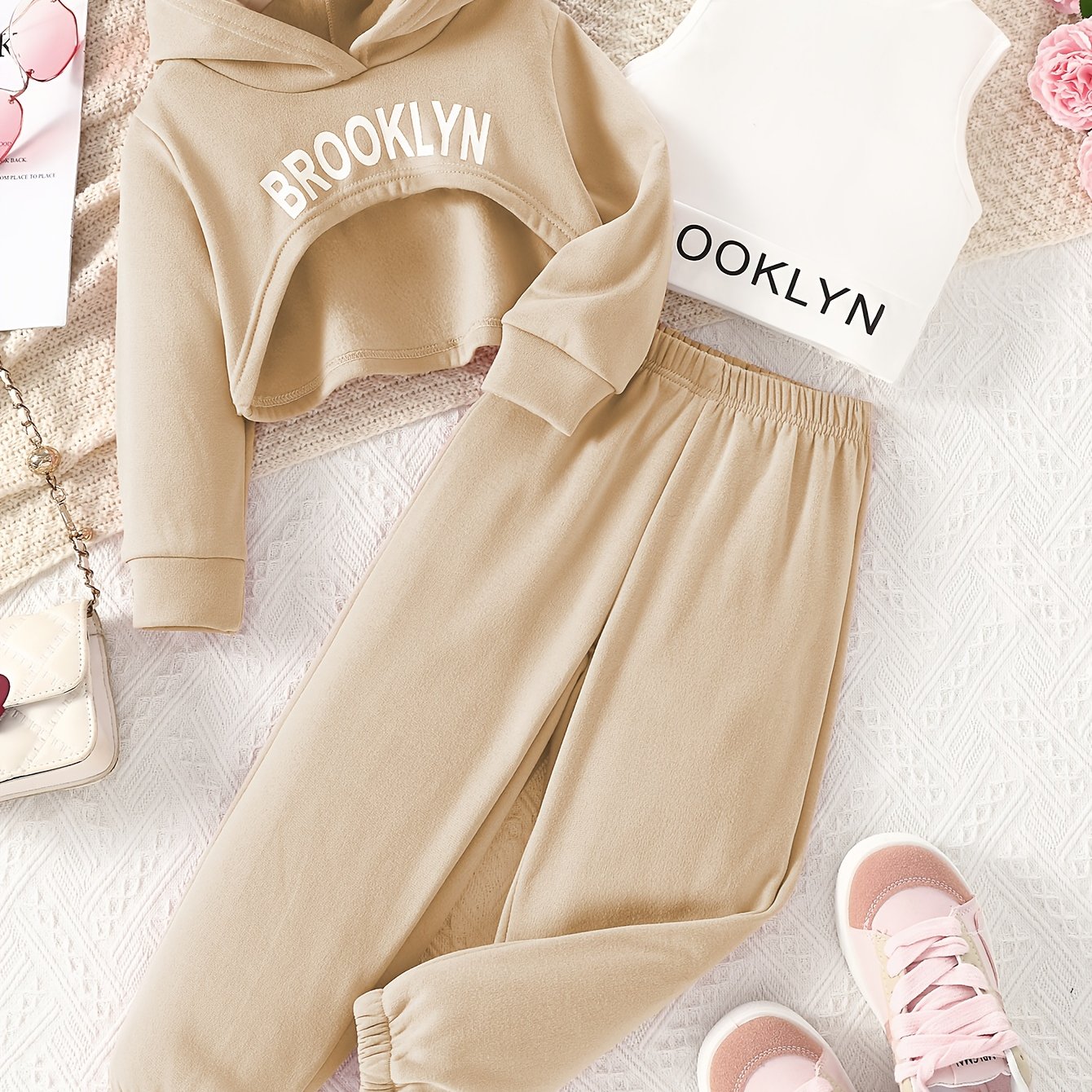 Stylish girls' outdoor clothing set for spring and autumn includes a hooded sweatshirt, vest, and pants with letter print. Perfect for casual or special occasions.