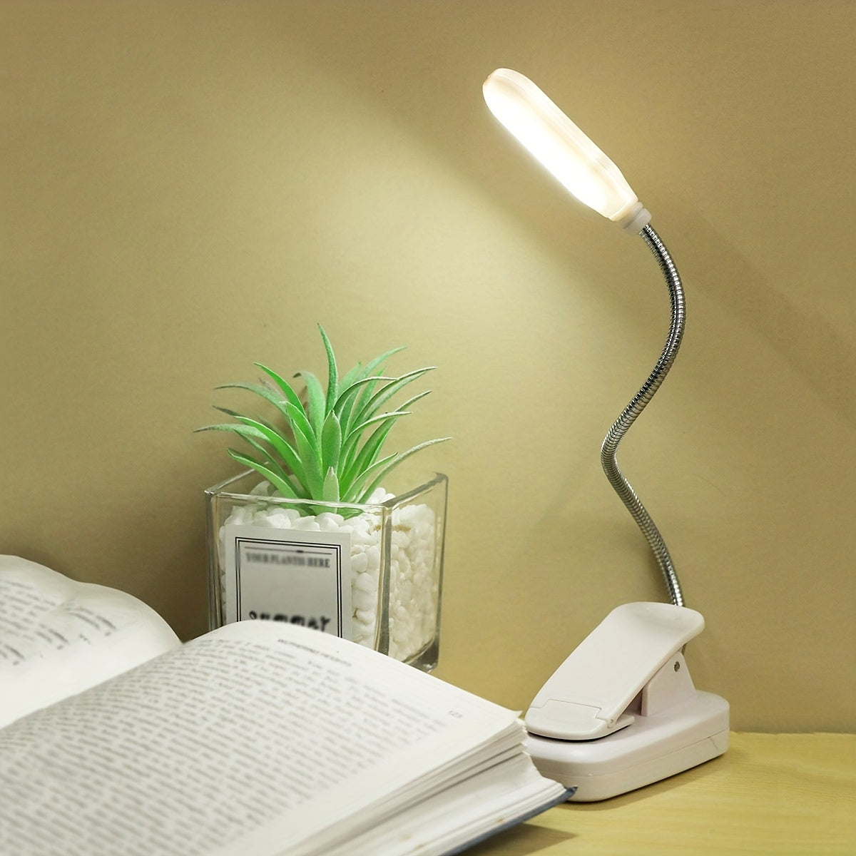 Portable battery-powered clip-on book light with a flexible hose, ideal for reading in small spaces or as a bedside night light.