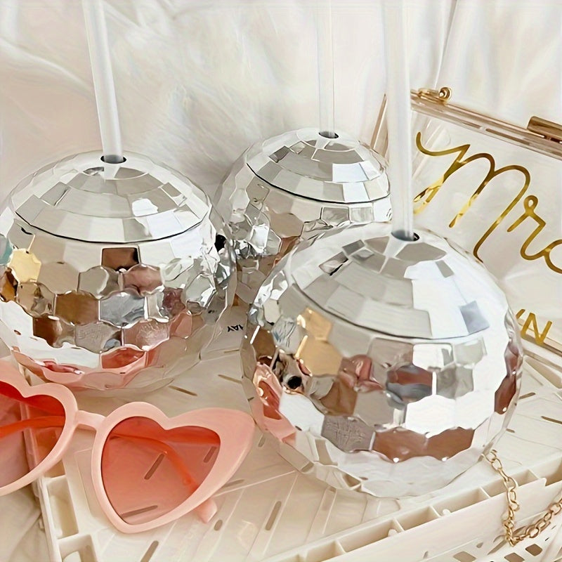 Spherical glitter ball cup with straw, perfect for parties.