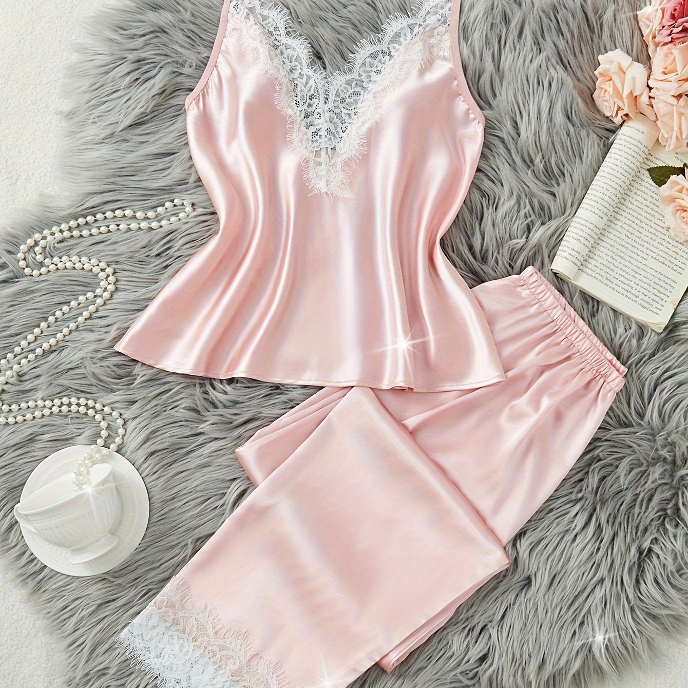 Women's lace pajama set with cami top and elastic pants for comfortable sleep and lounging.