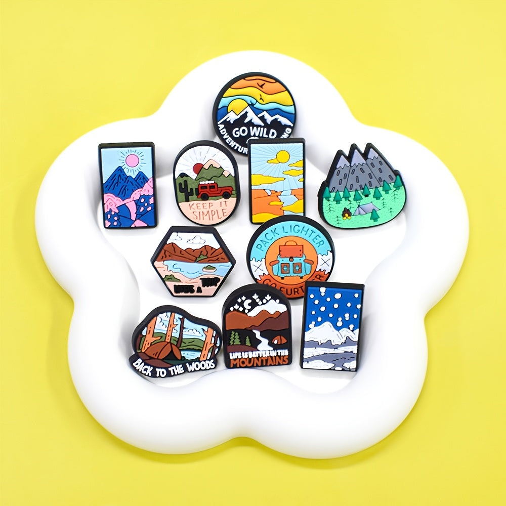 A set of 16 adventure-themed plastic brooch pins featuring travel and nature inspired designs such as trees, rivers, mountains, sun, car, and tent motifs. Perfect for backpack accessories, this holiday gift pin set is sure to inspire any nature lover.