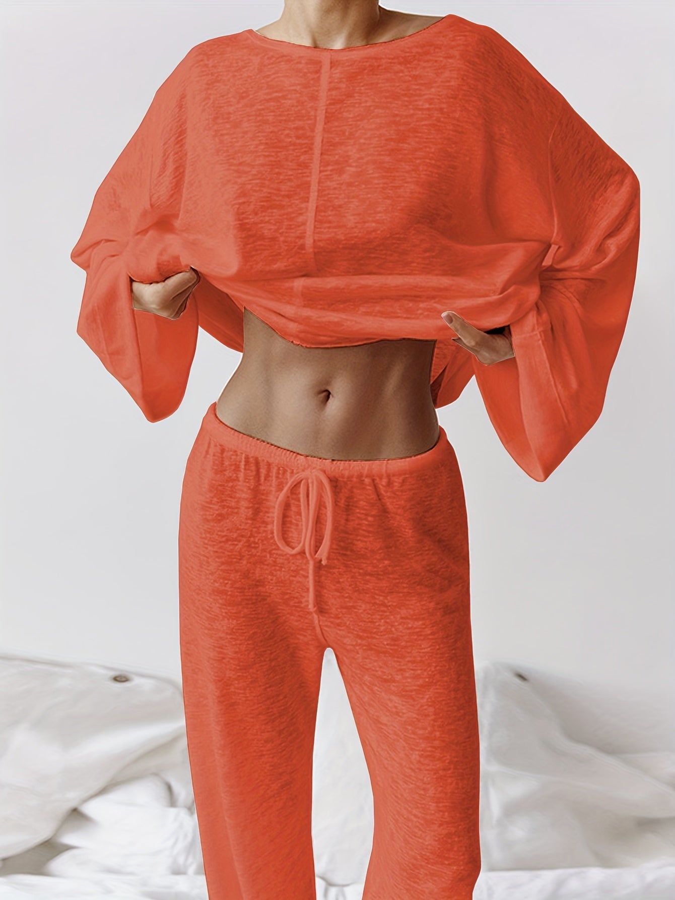 Women's two-piece set of loose and comfortable home clothes made with micro-permeable fabric, featuring round neck and long sleeves.