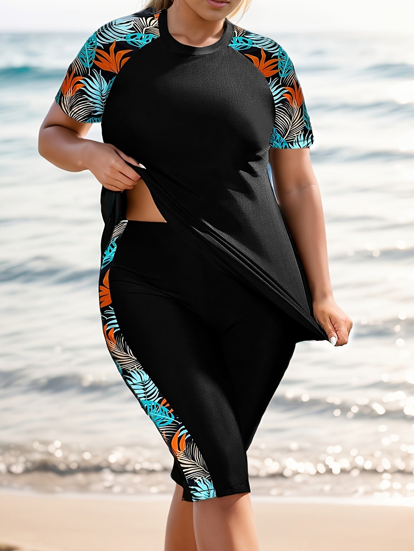 Tropical print swimsuit set for plus size women, made of stretchy polyester and elastane. Features round neck top with short sleeves and high-waist bottoms. Machine washable.