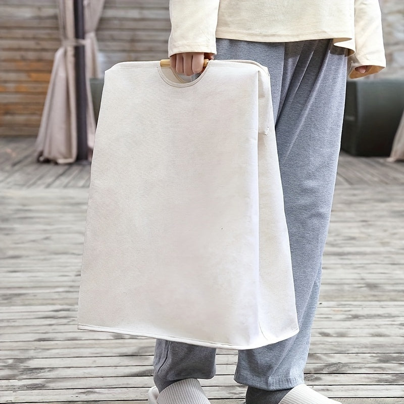 Fabric laundry basket with wooden handles, spacious enough for dirty clothes storage in home, bedroom, or bathroom.