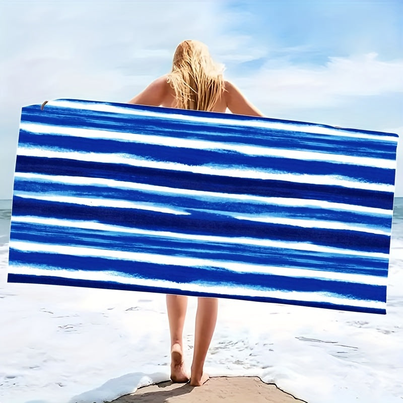 Oversized striped beach towel perfect for adventures. Made of super soft microfiber, quick-dry, sand-free, and ideal for various activities. Available in tropical blue & white. Comes in two sizes and is lightweight and absorbent.