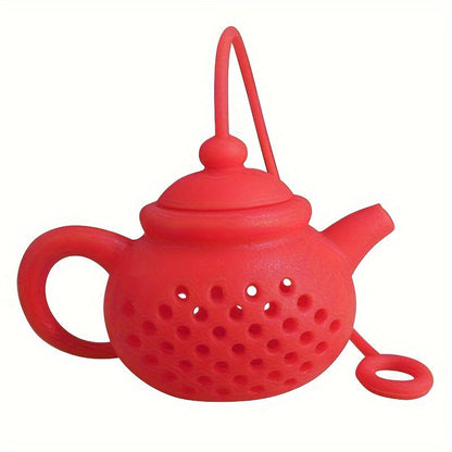 Reusable teapot-shaped tea infuser made of silicone for loose leaf tea, ideal for kitchen and dining use, small in size suitable for making tea.