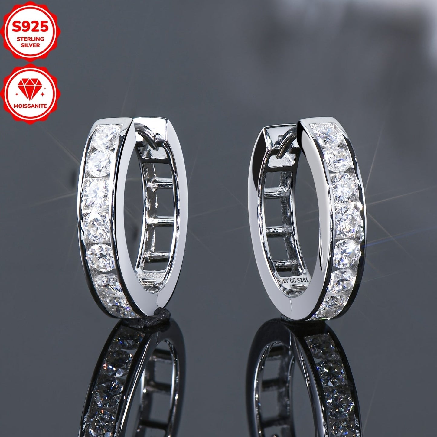 These stunning hoop earrings are crafted from 925 sterling silver and feature dazzling D color 2.5mm round moissanite stones in a track setting. The inner diameter of the earrings is 13mm, and they come with a GRA certificate. The total weight of the