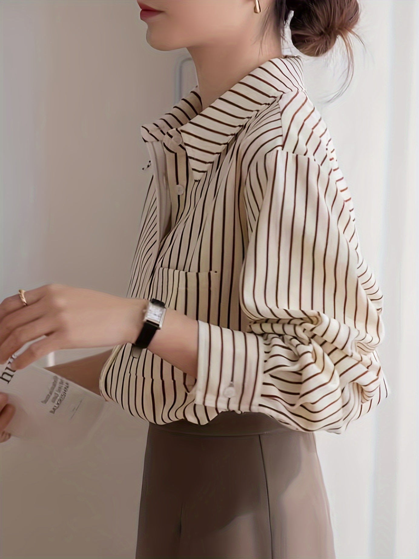 Beige striped blouse with button-up front, loose fit, machine washable.