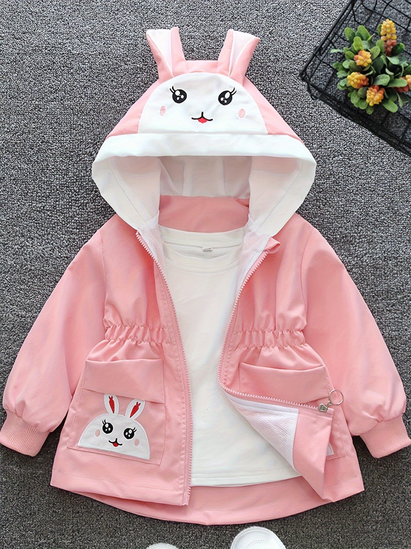 Girls' cute bunny-themed windbreaker in light pink, long sleeve, polyester blend, non-stretch fabric with pockets. Ideal for spring and autumn.