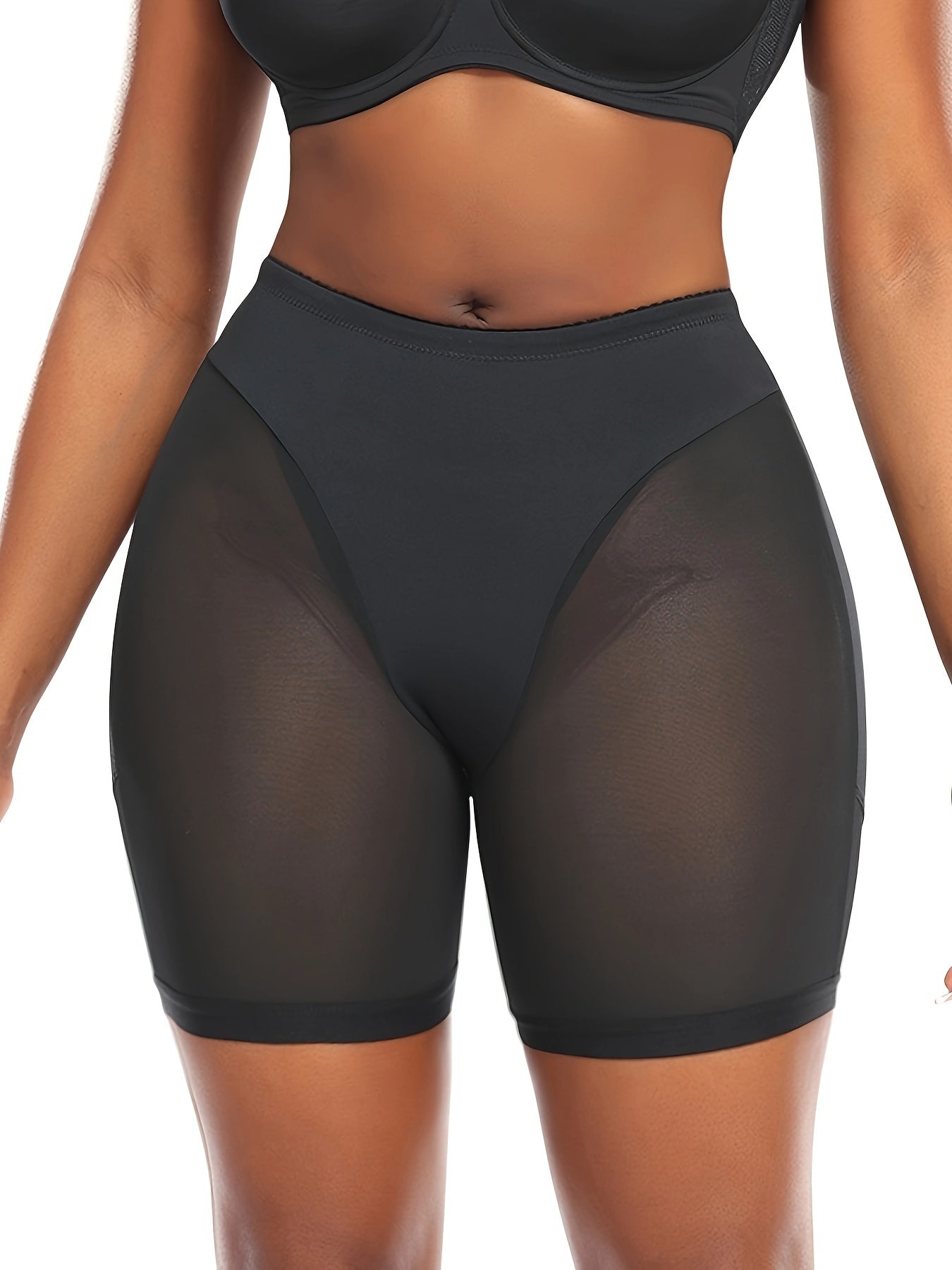 Slimming black shapewear shorts with high waist, tummy control, mesh panels, and a golden zipper detail. Made from a stretchy blend of polyester and elastane, providing mid-support.