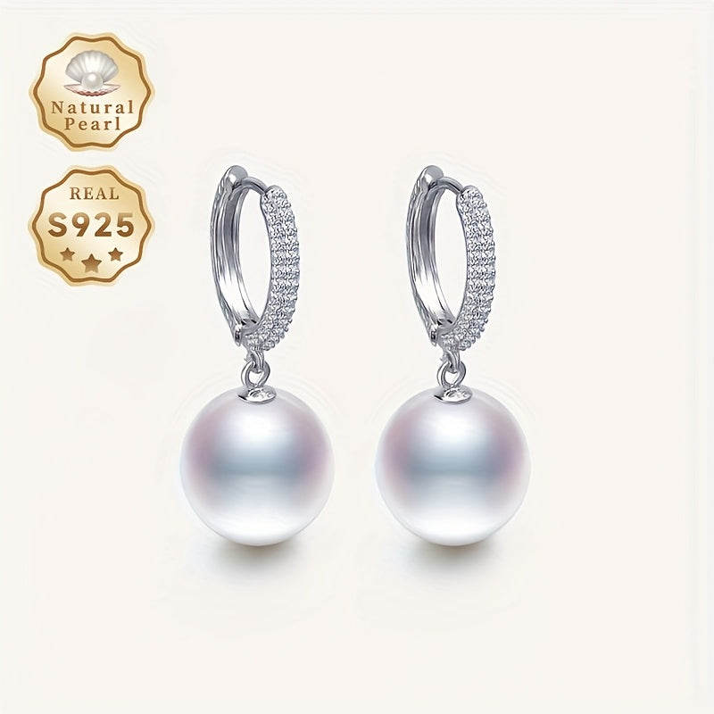 Get ready to dazzle with the luxurious elegance of these Daimi Hoop Earrings, made with 925 Sterling Silver and adorned with a natural Freshwater Pearl, the perfect June Birthstone gift for any occasion