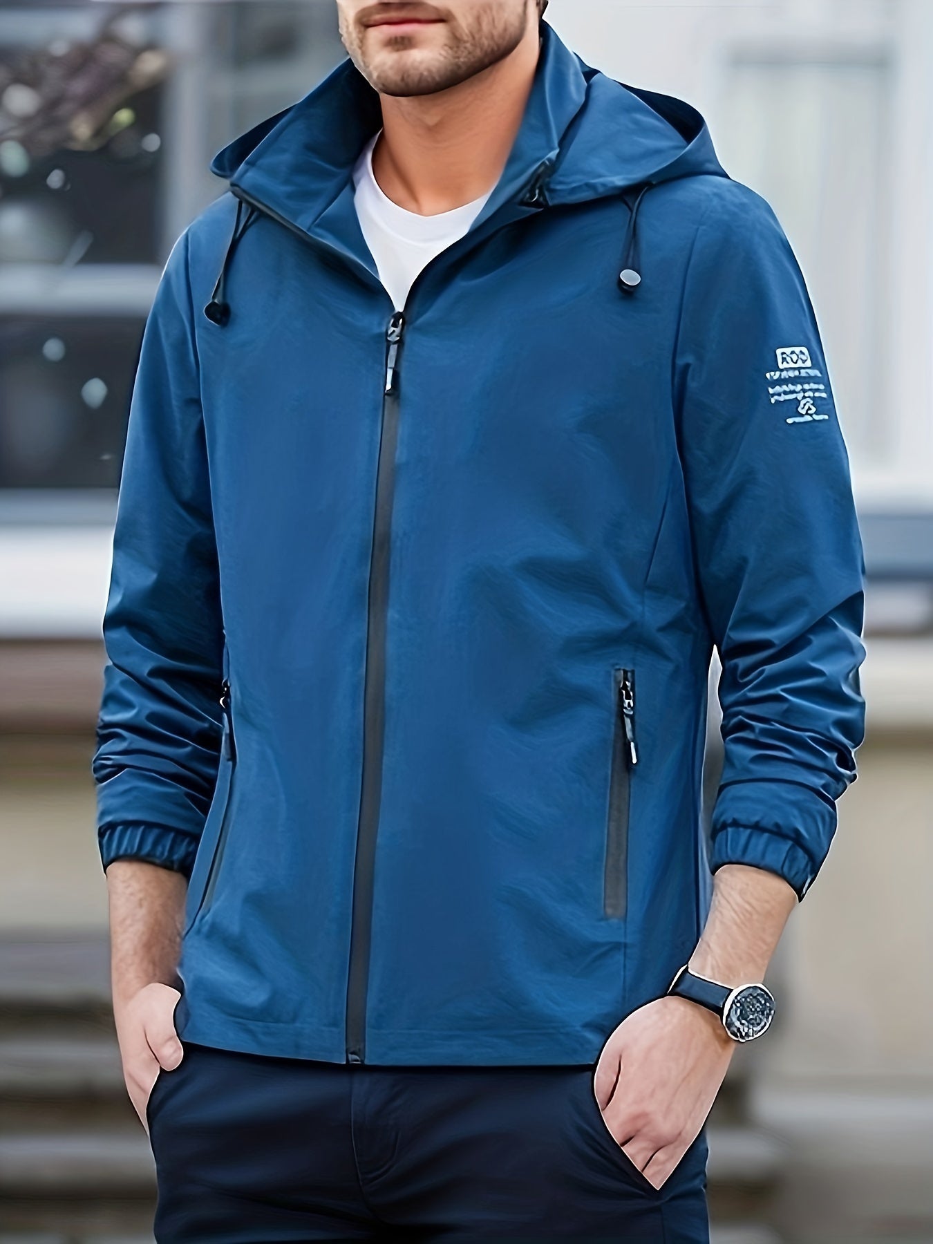 Men's lightweight softshell jacket with hood made of 100% polyester in a solid color. Features regular fit, long sleeves, zippered pockets, removable hood, outdoor casual style, woven