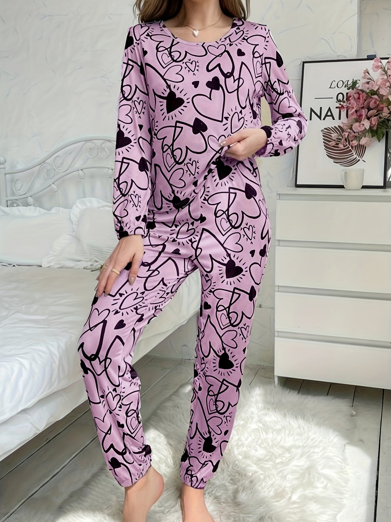 Women's lounge set with heart print, long sleeve top, crew neck, and elastic waistband pants for loungewear and sleepwear.