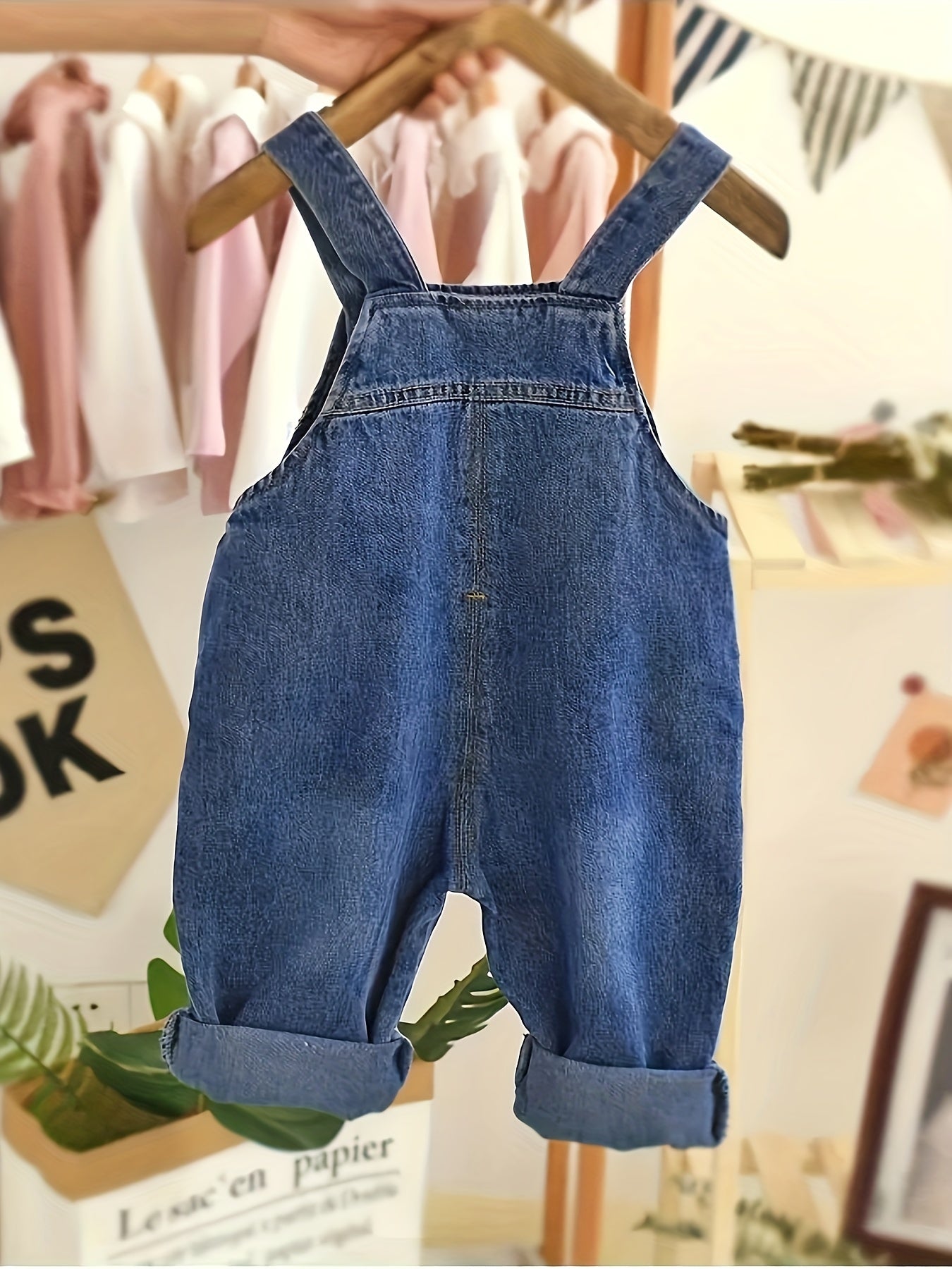 Infant & toddler girl's denim jumpsuit with pocket patches and ripped overalls, perfect for spring and summer.