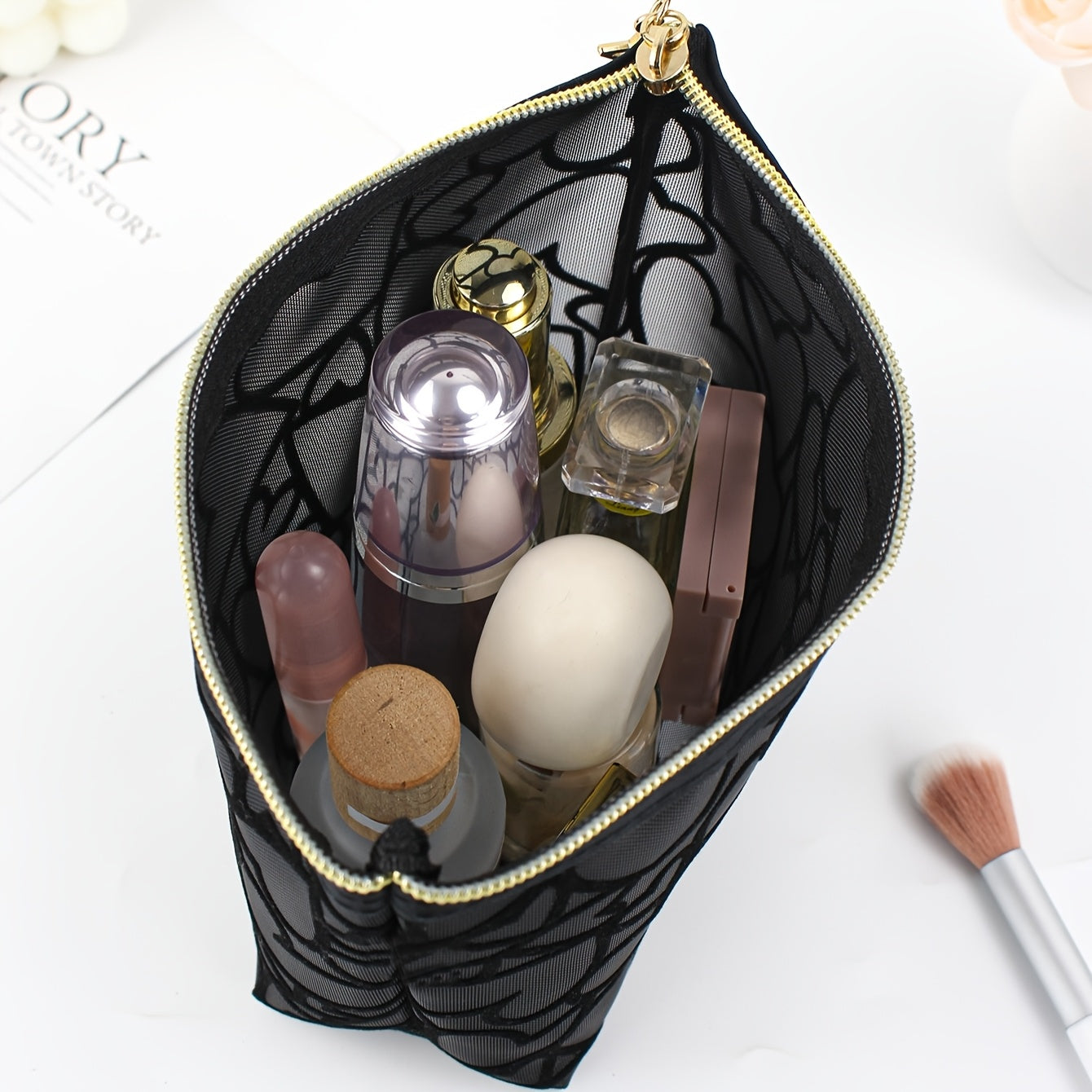 Black waterproof mesh makeup bag with a large capacity, zipper closure, and portable design for travel and toiletries.