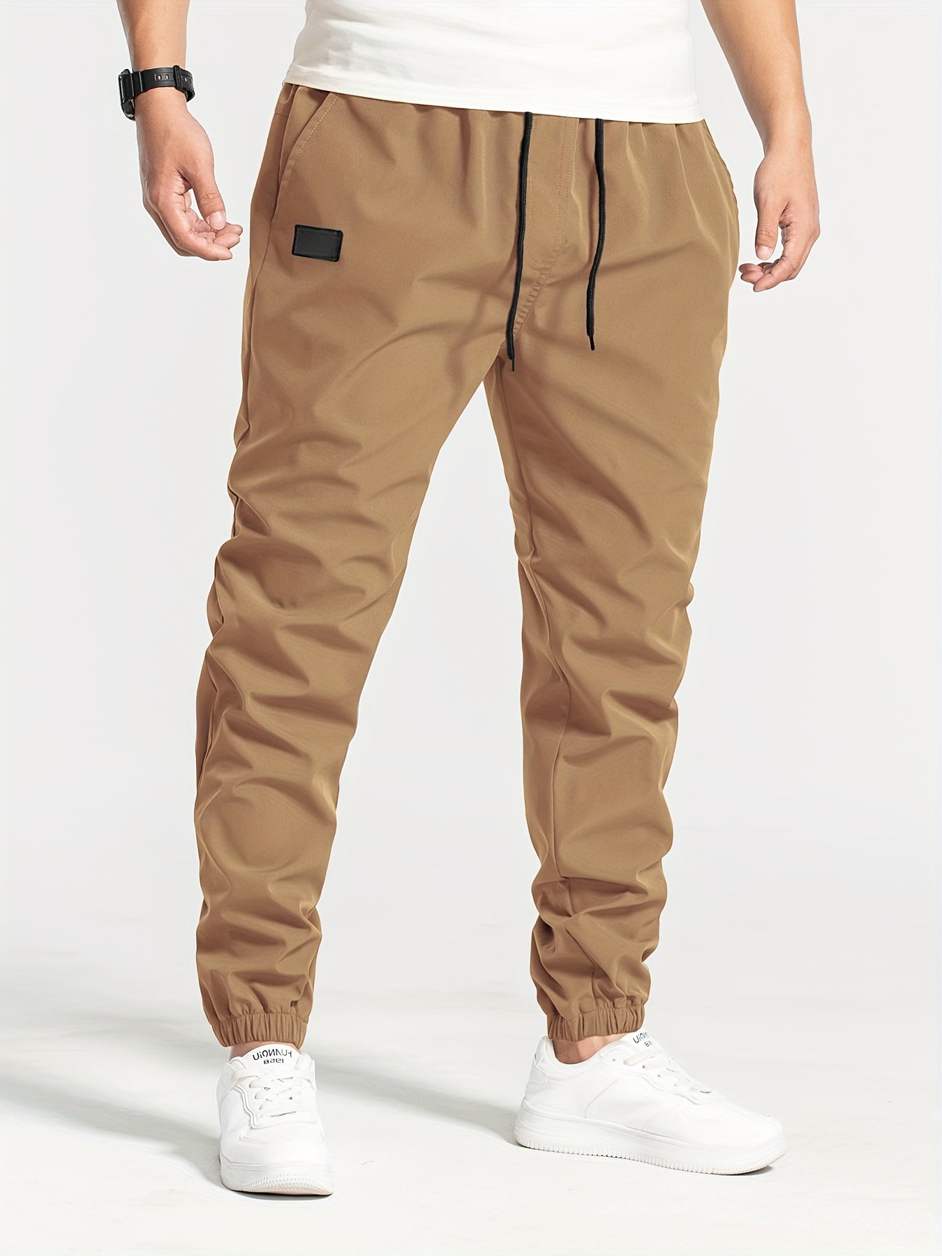 Three-pack of men's loose casual pants in 100% polyester solid color, featuring multi-pocket waist drawstring and non-stretch woven fabric, part of the Spring Collection, 180g/m².