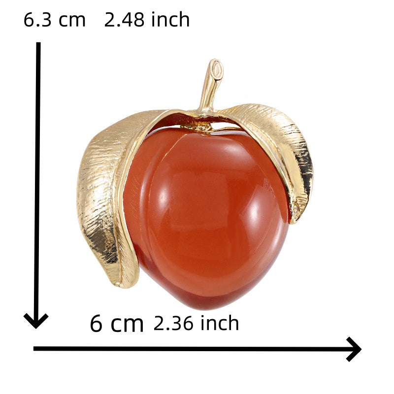 Vintage-inspired enamel brooch in a sophisticated peach design, featuring a high-end transparent finish. This fashionable fruit-shaped pin is a stylish accessory for clothing and suits.