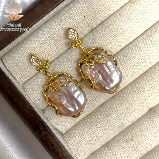 Elegant and luxurious French-inspired freshwater pearl earrings with gold-plated silver leaf accents, perfect for fashion-forward women with a taste for retro style and natural beauty.