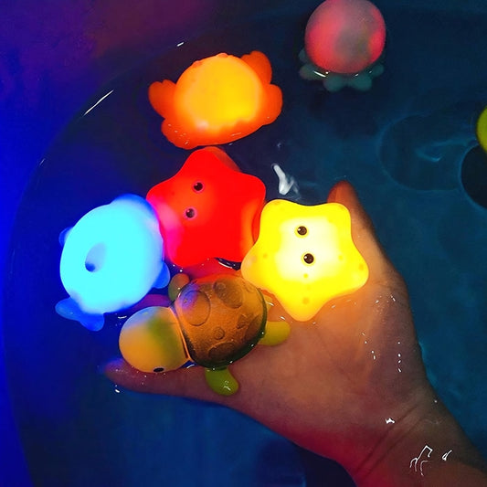 Colorful glow-in-the-dark bath toy set of luminous ocean animals made of PVC, with batteries included. Fun and educational bathtub game for youngsters.