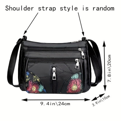 Men's fashion shoulder bag with large capacity, soft faux leather, floral embroidery, zipper closure, and casual messenger style.