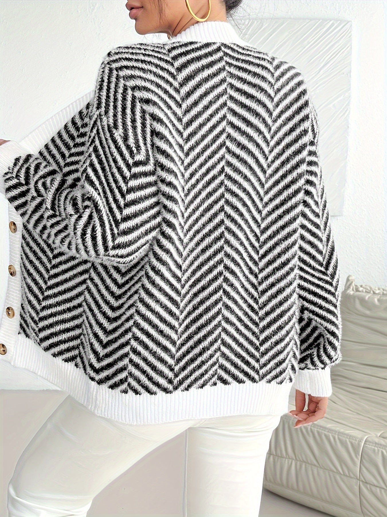 Stylish women's zebra stripe cardigan in black and white. Features button front, long sleeves, and V-neck. Made of a casual polyester blend for fall/winter. Perfect for trendy fall fashion.