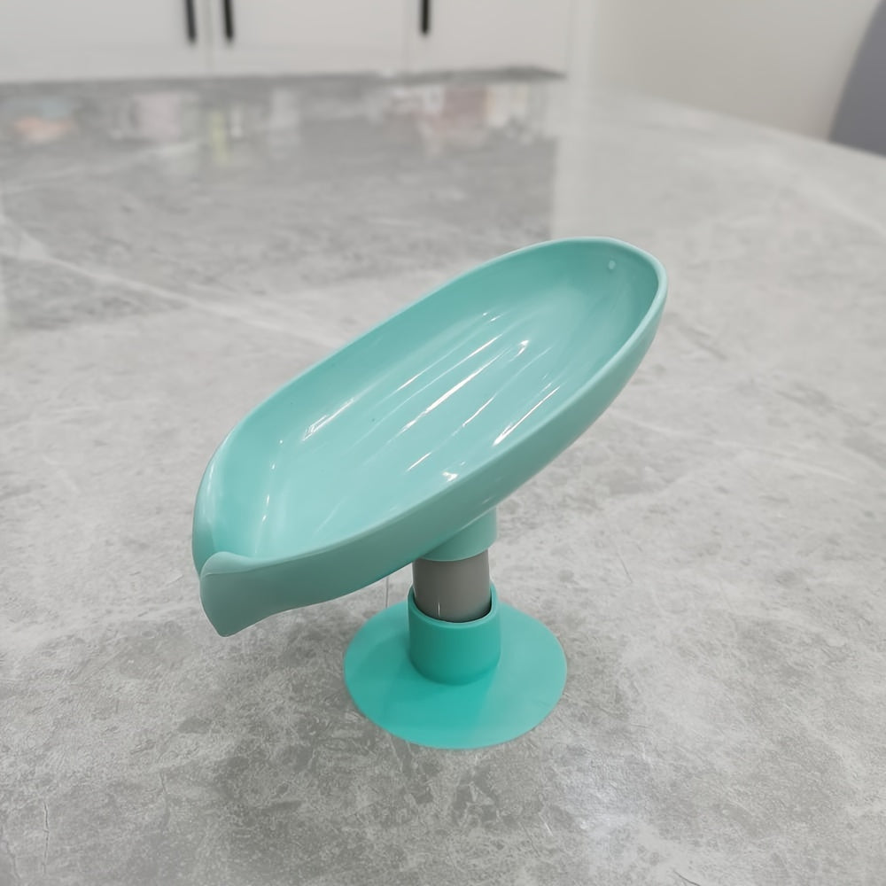 Plastic oval soap dish with suction cup design for home use.