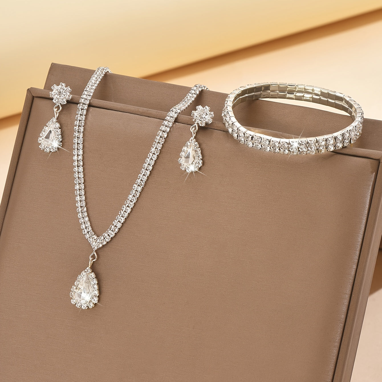 This exquisite collection features luxurious women's jewelry adorned with shimmering water diamonds, including a stunning necklace, elegant earrings, and a versatile stretch bracelet. Perfect for adding a touch of glamour to any party or dance.