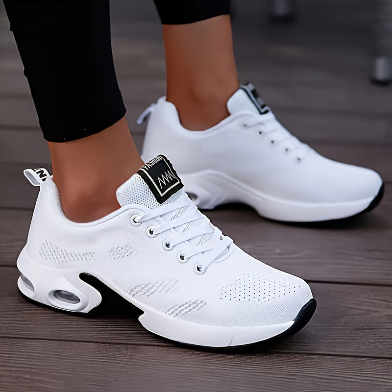 White running shoes for women with breathable knit material, air cushion sole, and shock-absorbing platform design.