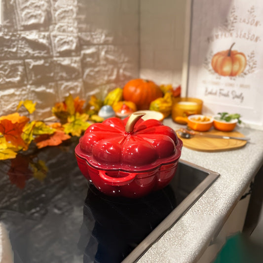 Red pumpkin-shaped cast iron casserole pot with enamel Dutch oven lid, thick saucepan suitable for gas and induction cooktops, kitchen cookware.