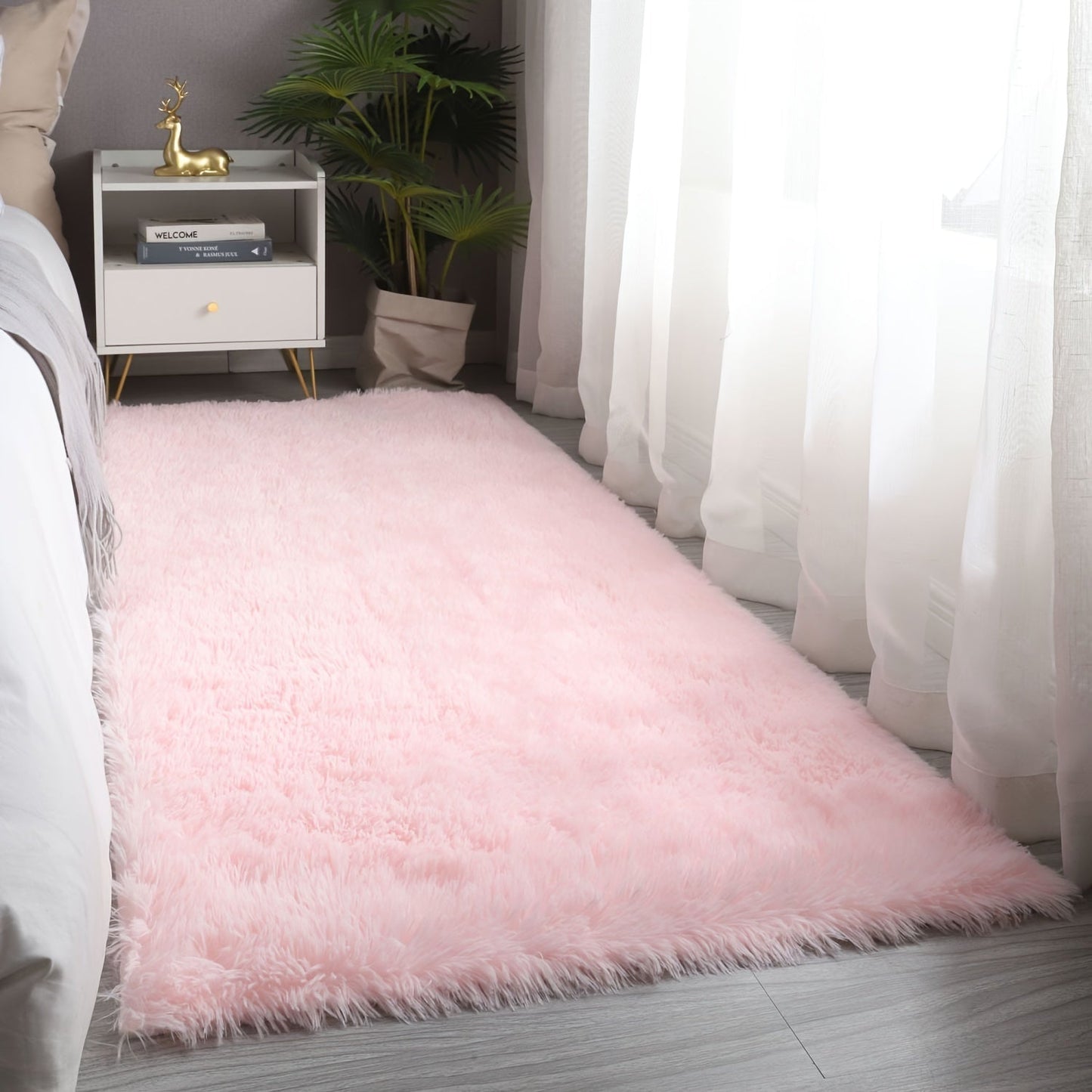 Soft and fluffy pink area rug, machine washable with a shaggy design. Perfect for adding a cozy touch to any living room, nursery, or dorm room. Non-slip and aesthetically pleasing.