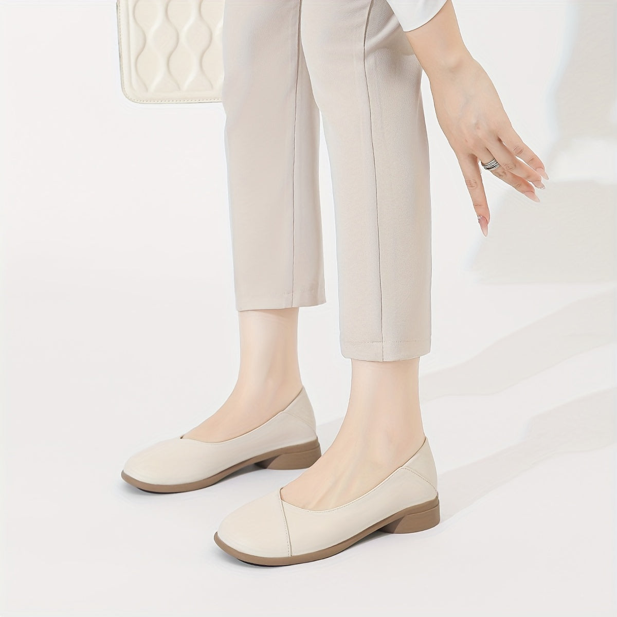 Stylish white low heel flats with all-day comfort for work.