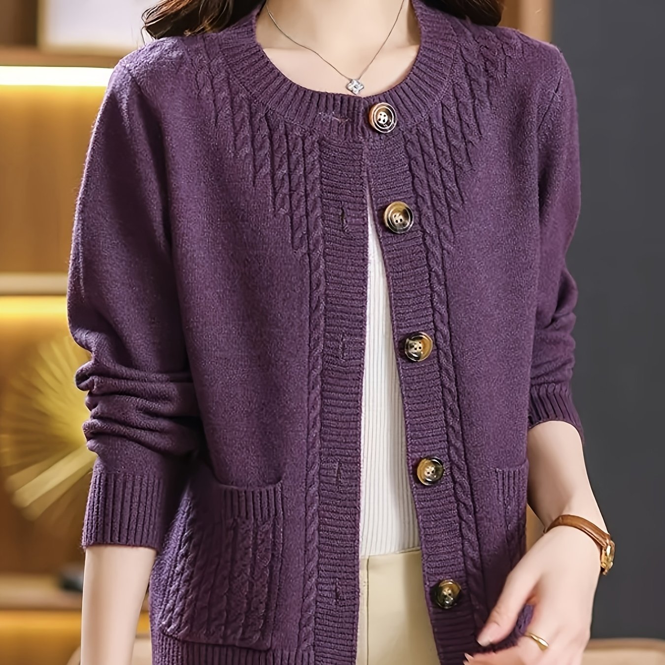 New Spring Collection for Women: Loose-fitting cardigan with round neck, solid color, and unique design, featuring long sleeves.