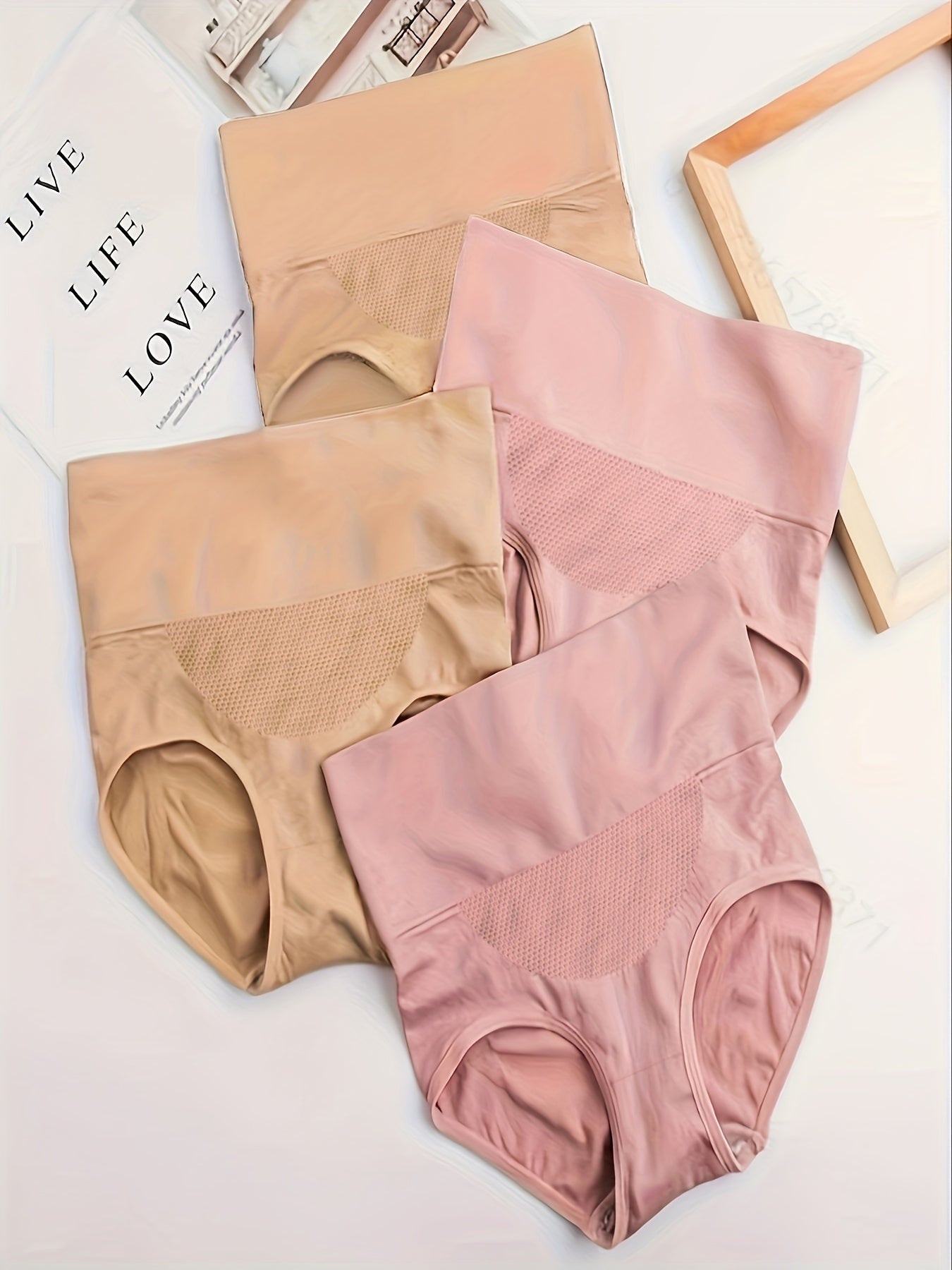 Four pieces of butt-lifting briefs with high waist, tummy control, and breathable fabric, ideal for women's lingerie and underwear.