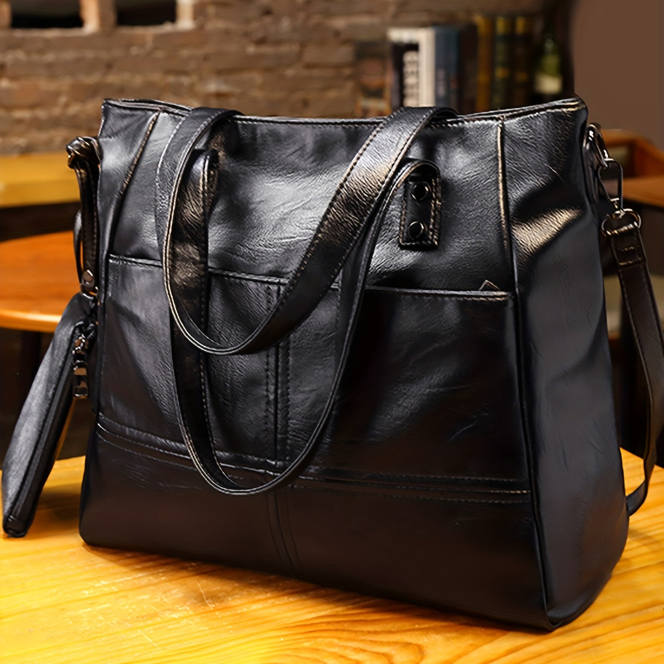 Fashionable black quilted shoulder bag with removable strap, large capacity, anti-theft zipper closure, polyester lining, and clutch accessory - ideal for stylish commuters.