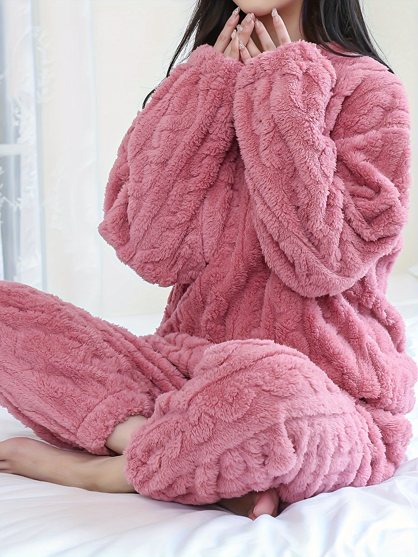 Soft pink fleece pajama set for women, long sleeves, round neck, warm and cozy for fall/winter, easy care machine washable.