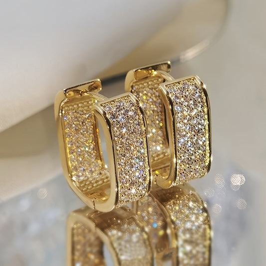 This attractive pair of CZ hoop earrings, featuring a simple and versatile design, is perfect for women. Made with 18k gold-plated metal, these trendy earrings are sure to add a touch of sophistication to any outfit. Ideal for everyday wear or special