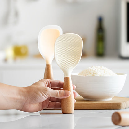 Heat resistant silicone spoon with wooden handle for non-slip rice cooker. Practical kitchen tool for home, school, and dorm.