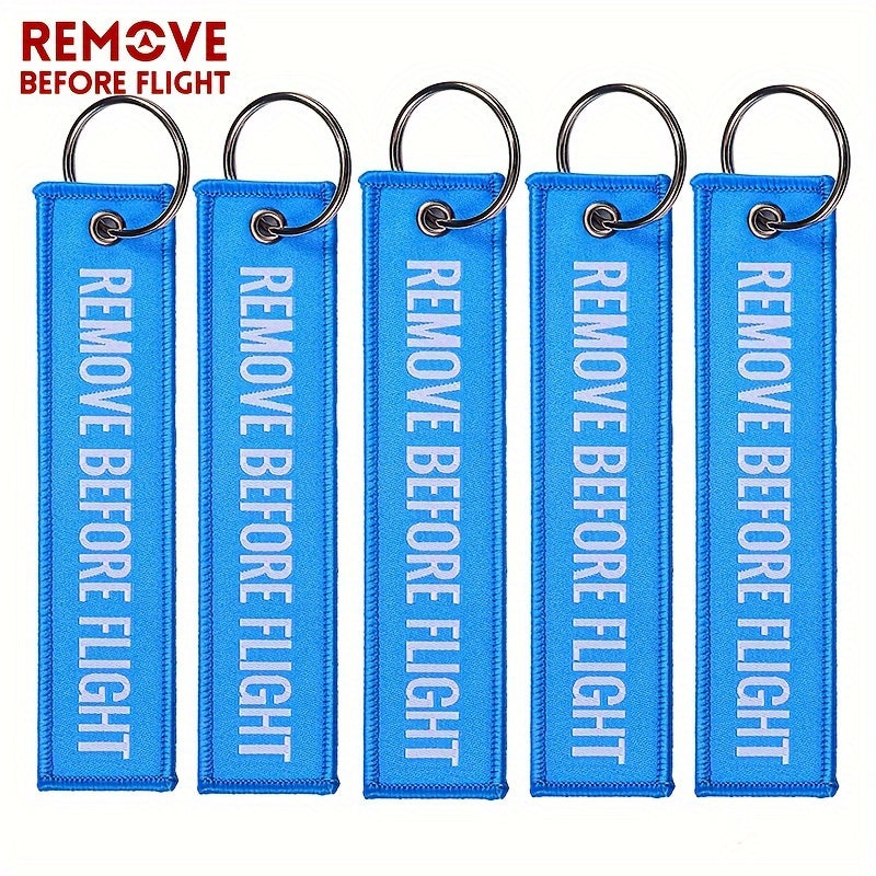 Bundle of 50 'Remove Before Flight' Woven Keychains made from sturdy polyester material - Ideal present for pilots and aviation fans, featuring the iconic phrase "REMOVE BEFORE FLIGHT