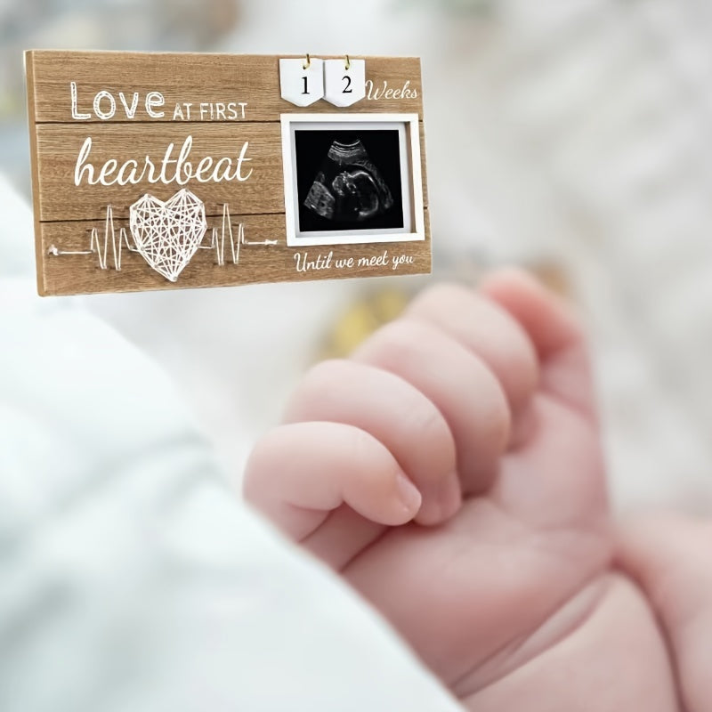 Baby countdown photo frame made of wood featuring a heartbeat design. This newborn keepsake frame is suitable for children aged 0-3 years and comes with interchangeable week tracker blocks.