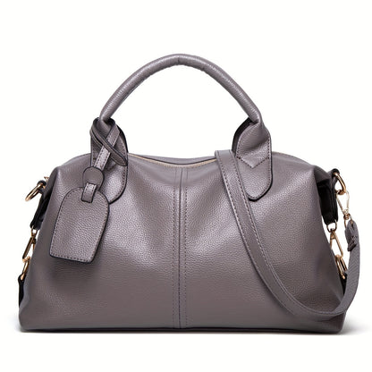 Stylish shoulder bag with removable strap and zip closure, perfect for everyday use.