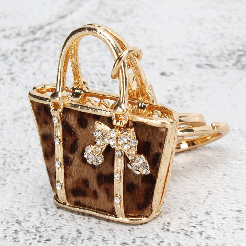 Golden leopard pattern bag shaped keychain pendant, perfect for adding charm to your car, wallet, handbag, or phone. This versatile accessory is also ideal for decorating during the Christmas season, making it a great gift for women.