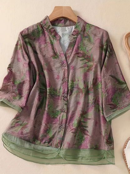 Women's floral print shirt with high neck, three-quarter sleeves, and cross hem. Made of polyester in a regular fit for weekend wear.