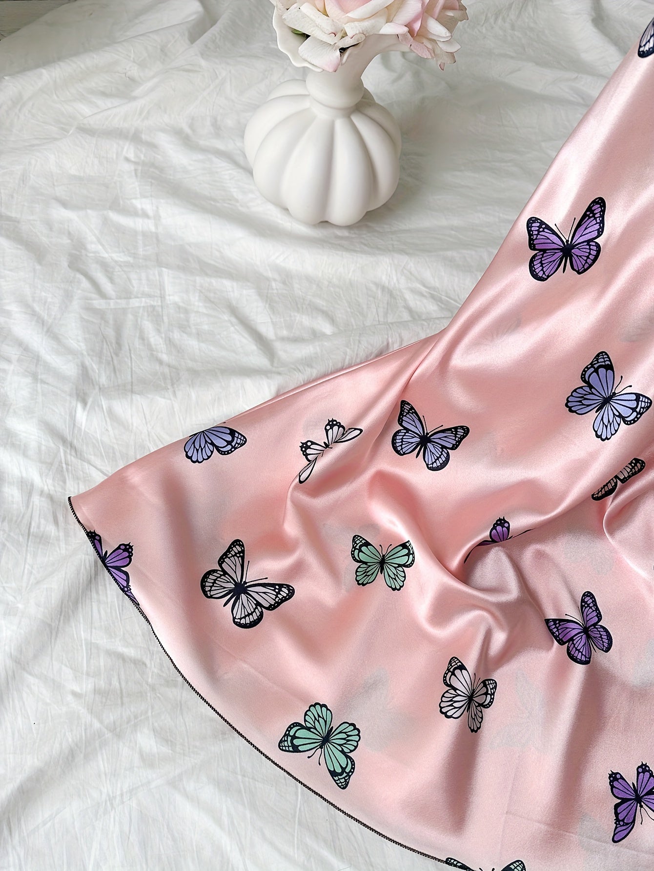 Satin nightgown with butterfly print and adjustable cross straps, perfect for women's sleepwear.