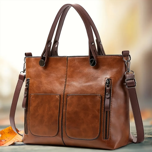 Vintage-style tote bag with zipper closure, brown synthetic leather, multiple compartments & adjustable strap, ideal for work or casual outings.