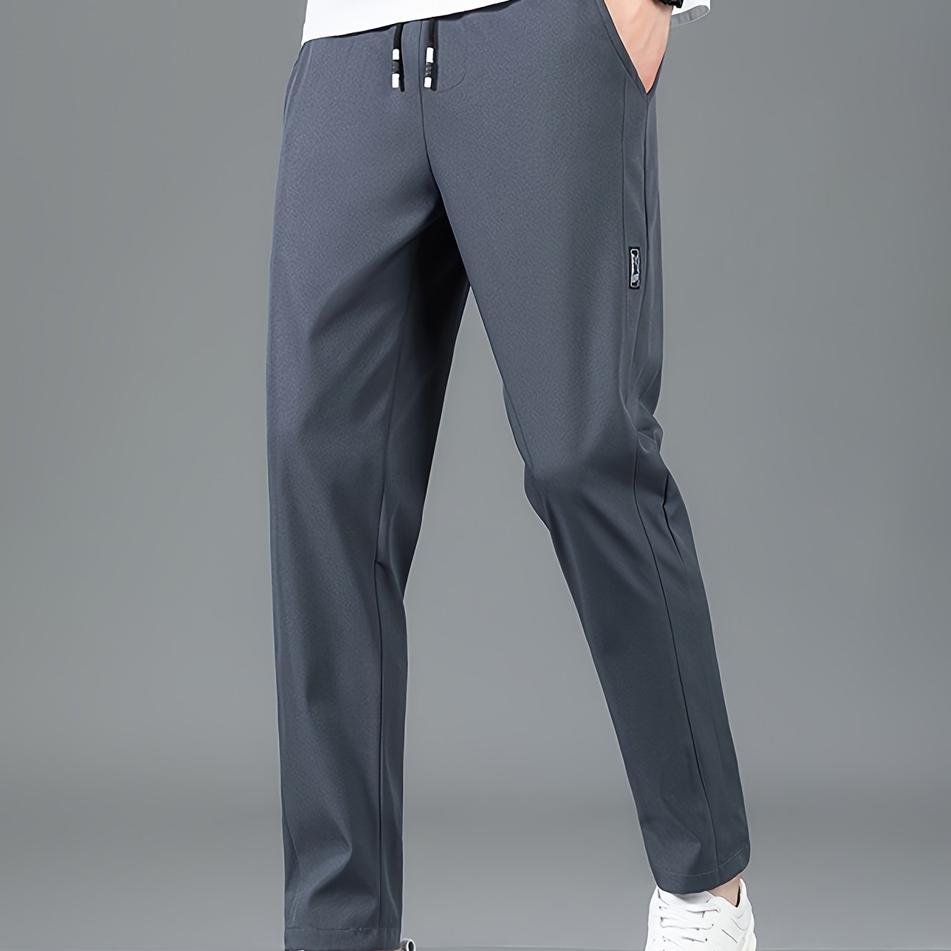 Men's casual straight-leg pants in solid color, made of non-stretch polyester and machine washable. Ideal for spring and fall.