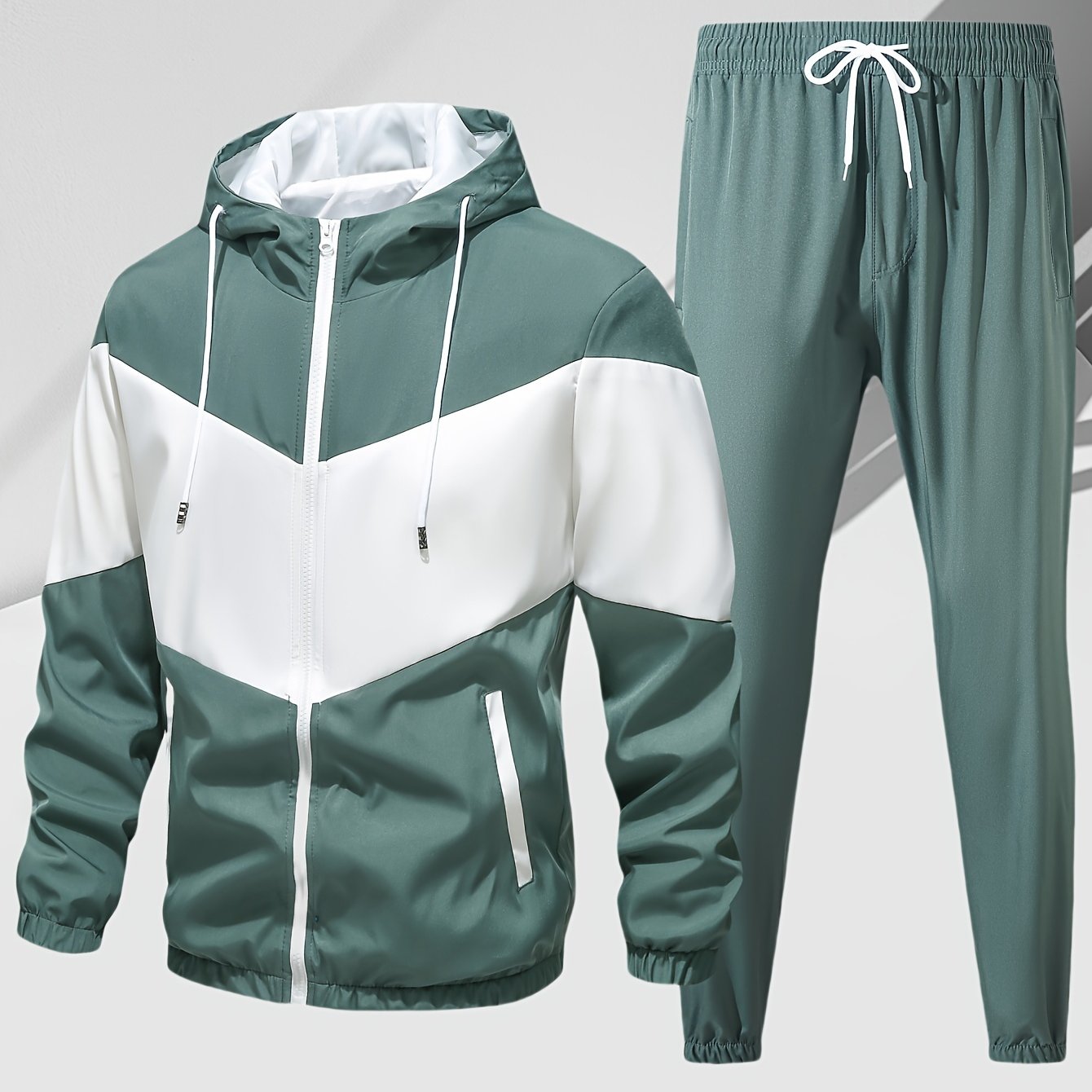 Men's casual 2-piece outfit with a stylish color block zip up hooded jacket and breathable drawstring pants.