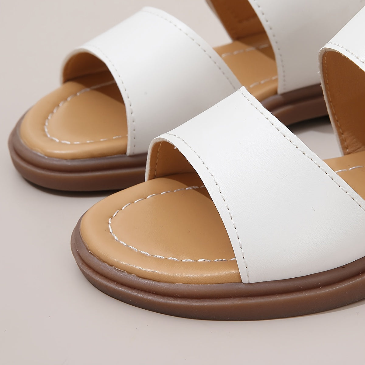 Stylish summer sandals for girls: open-toe design with braided straps and flat sole, ideal for casual wear and festivals.