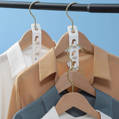 4-piece heavy-duty plastic hanger set with 3 hooks for efficient storage of clothes. Easy to install and a modern wardrobe essential. Great for shirts, jeans, scarves, and coats.