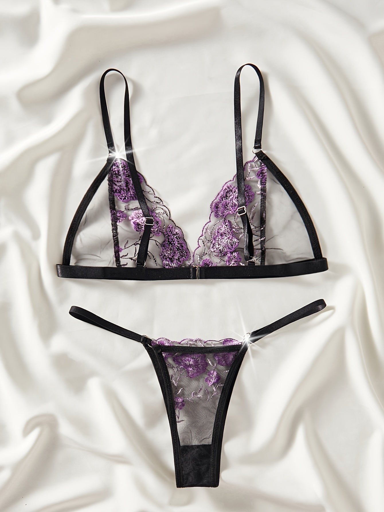 Floral embroidered lingerie set with sheer mesh bra and thong for women.